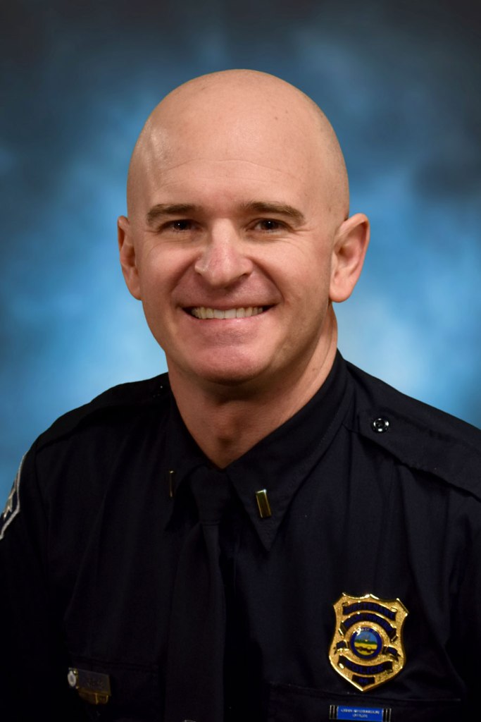 A portrait of Lt. Dan Tobias in front of a blue background.